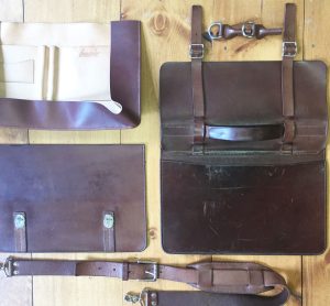 disassembled leather messenger bag